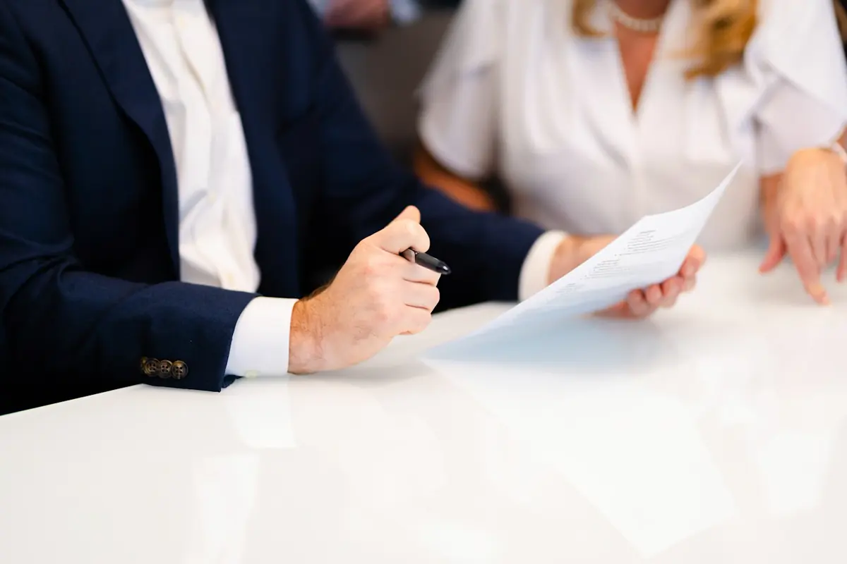 Attorney reviewing a document with a client across a desk